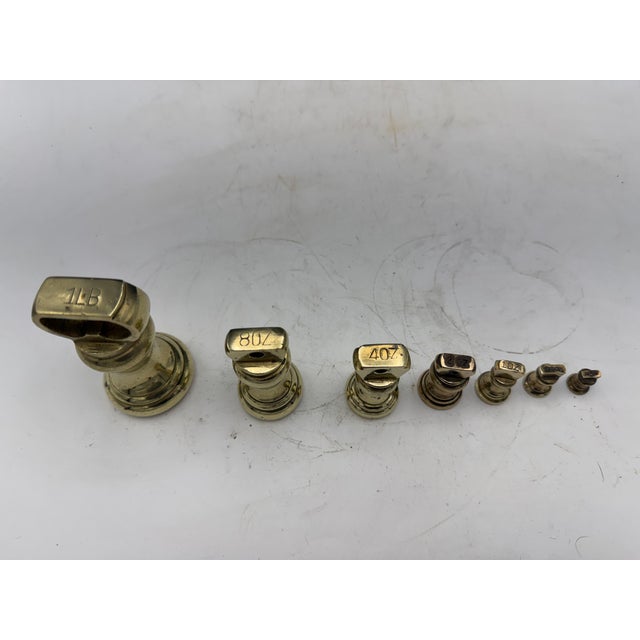 A set of seven solid brass Antique scale weights. The set of weights are 1lb, 8 oz, 4oz, 2oz, 1oz, 1/2oz and 1/4oz... All...