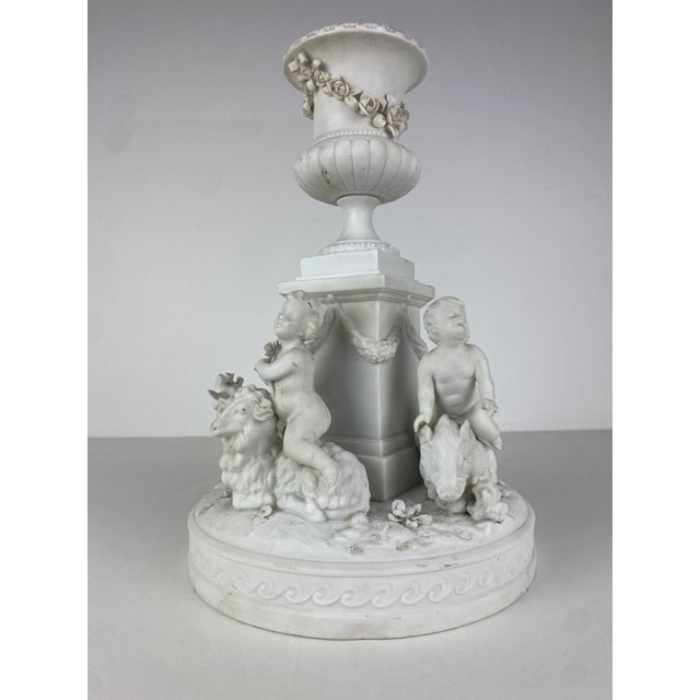 Late 19th-century Biscuit Porcelain Centerpiece. The base features a richly sculpted, three-dimensional decoration...