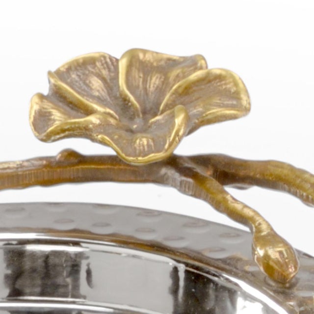 Beautiful hammered stainless steel tray with antique brass orchids. This exquisite oval tray is ideal as a stand alone or...