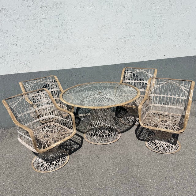 Exceptional mid-century spun fiberglass dining set featuring four armchairs and a coordinating pedestal table. The...