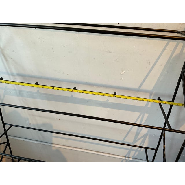 A pair of steel wall shelves. Interesting detail to the metal.No glass.