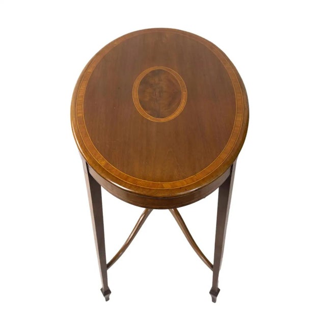 Satinwood Occasional Table, inlaid banding and stringing convex stretcher with finials to the top and bottom, on elegant...