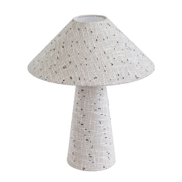The Fischer table lamp has the kind of texture you can't help but reach out and touch. Thick, twisted boucle yarns wrap...