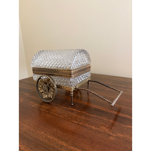 A very rare vintage cut crystal jewelry carriage box with bronze mounts. The domed crystal box sits on a bronze carriage...