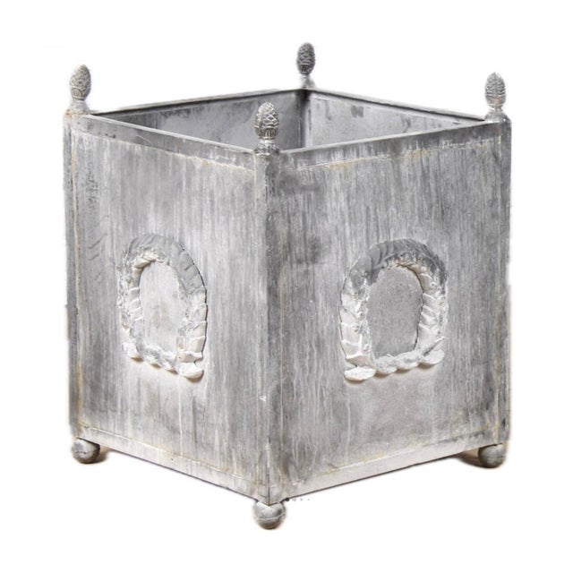 Pair of Classical metal planters with wreath motif. A pair of American Neoclassical style metal planters with grey...