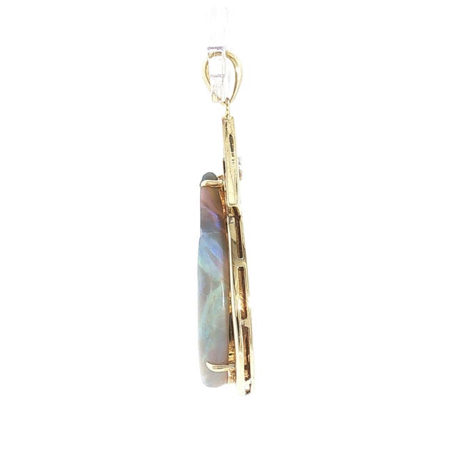 A Mid-century 14k gold grey-based opal and diamond pendant. The opal is pear-cut, weighing approximately 12.0 carats, with...