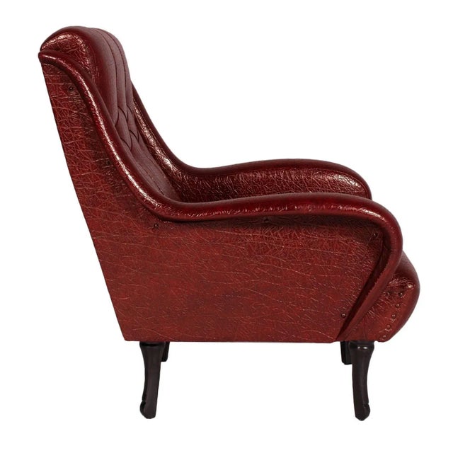 This lounge chair in the style of Zanuso was produced in the 1950s. It features leatherette upholstery and ebonized wood...