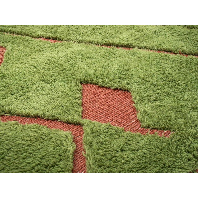 This striking 3.02 x 2.12 m hand-knotted wool rug blends earthy sophistication with bold contemporary design. Crafted from...