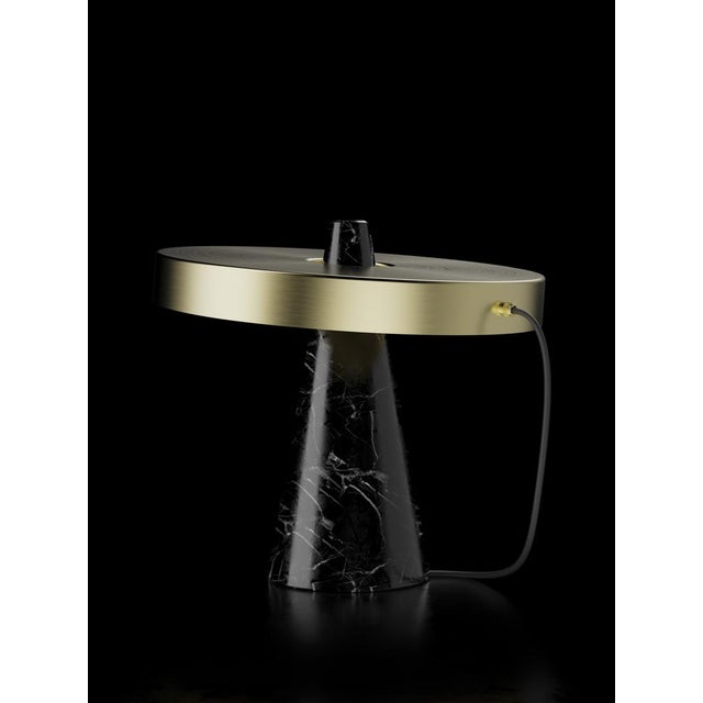 Table lamp with Marquinha black stone base and brushed brass lightshade. The light shade is disconnected from the stone...