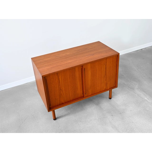 Vintage sliding door cabinet in teak by Hans Wegner for RY Möbler. This model hails from the RY100 series and features...