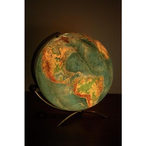 Columbus globe with light designed by Paul Oestergaard in the 60’s. This globe has a brass base and can be turned in two...