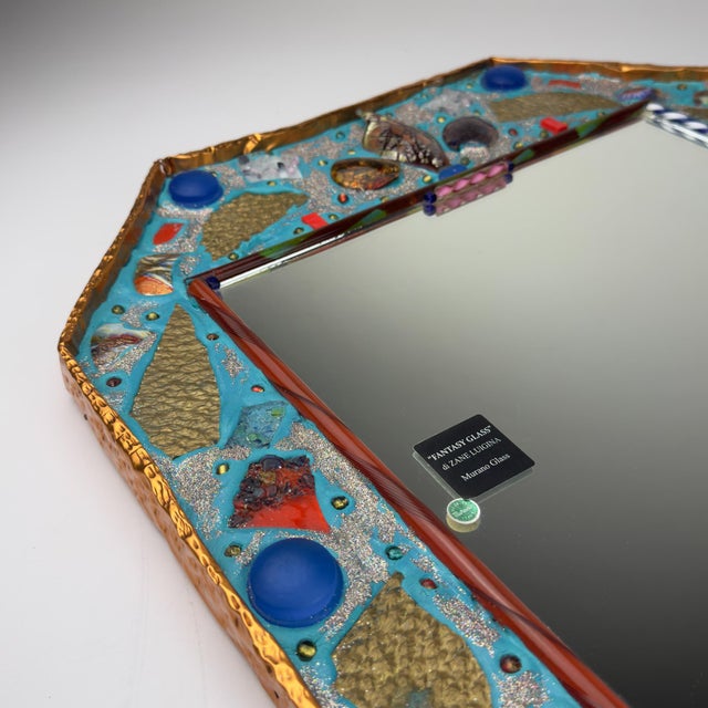 A unique and highly decorative italian wall mirror crafted on the island of murano by the now-closed artisan studio...