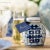 The symbol for double happiness adorns this petite tea leaf jar with best wishes for love, companionship and marital...