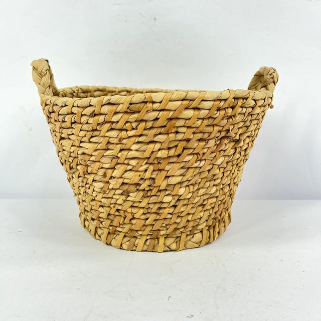 Handwoven basket made by the Tonga people of Zambia. Traditionally crafted from natural plant fibers, these baskets are...