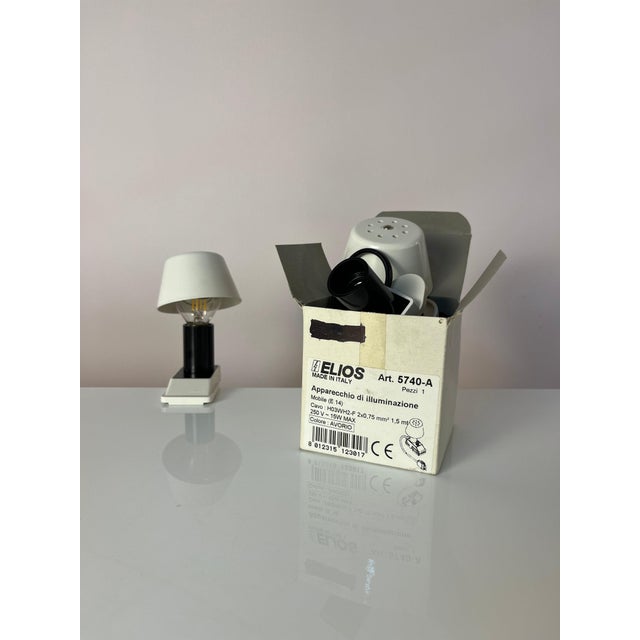 This white clamp lamp from Elios is a collector's item from the Italian design house Elios, bringing the playful charm of...