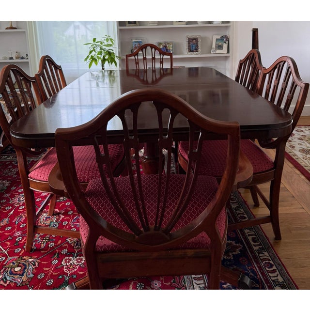 A magnificent, single-family mid-century formal dining set featuring a solid mahogany double-pedestal table from Drexel’s...
