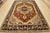A traditional tribal Heriz rug hand-knotted with an all-wool pile on a cotton foundation. This oriental rug features a...