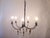 This rustic wrought iron chandelier has wooden pendants and uses up to 60 Watt candelabra bulbs.