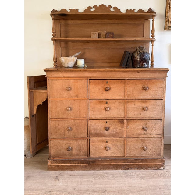 This rare 19th century English pine dairy hutch showcases a wonderfully practical and unusual form, anchored by a full...