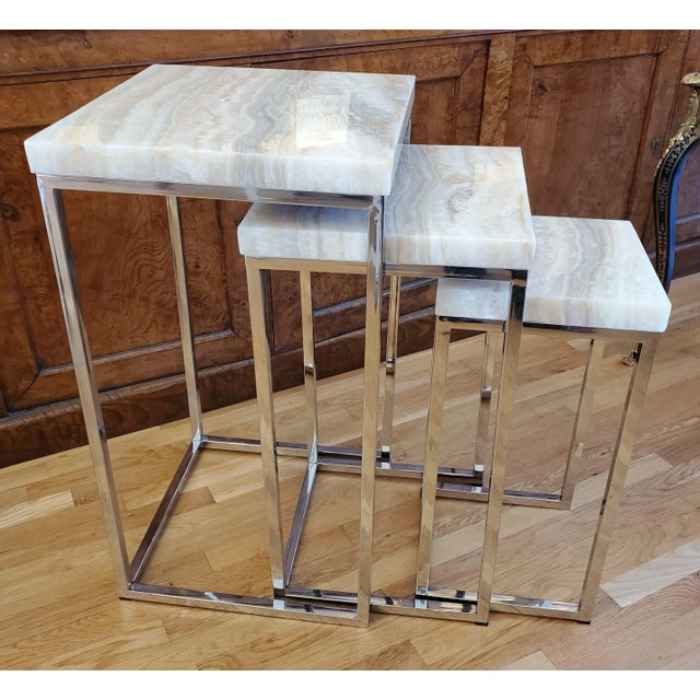 A stunning set of three Mid-Century Modern nesting tables made in Italy, circa 1960. These sculptural tables feature...