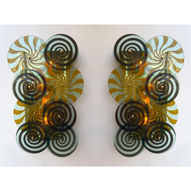 Pair of wall lights lamps sconces in brass and spiral discs Murano glass, Contemporary work from a small italian design...