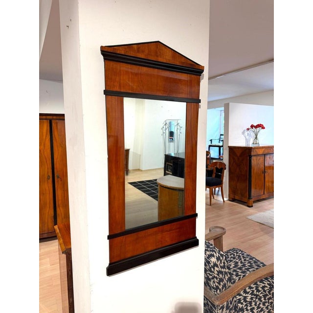 Early Biedermeier (neoclassical) wall mirror from South Germany, circa 1820. Cherry wood veneer on softwood. Several...