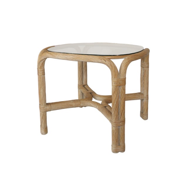 A coastal style rope twist rattan and bamboo glass top side table. Twisted rattan wraps a bentwood bamboo frame that...