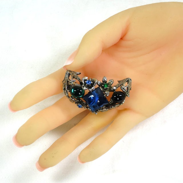 Vintage 1940s silver-plated crystal and glass brooch. Three-dimensional design of elements from nature entwined around a...