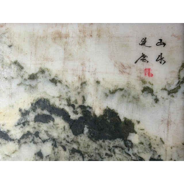 This decorative display piece features a smooth, polished marble panel encased within a dark, finely finished wooden...
