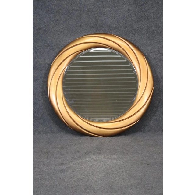 This is a gorgeous gold beveled glass mirror. Measures 41.25 wide x 41.25 across x 1.5 inches deep. Dates to the 2000s era...