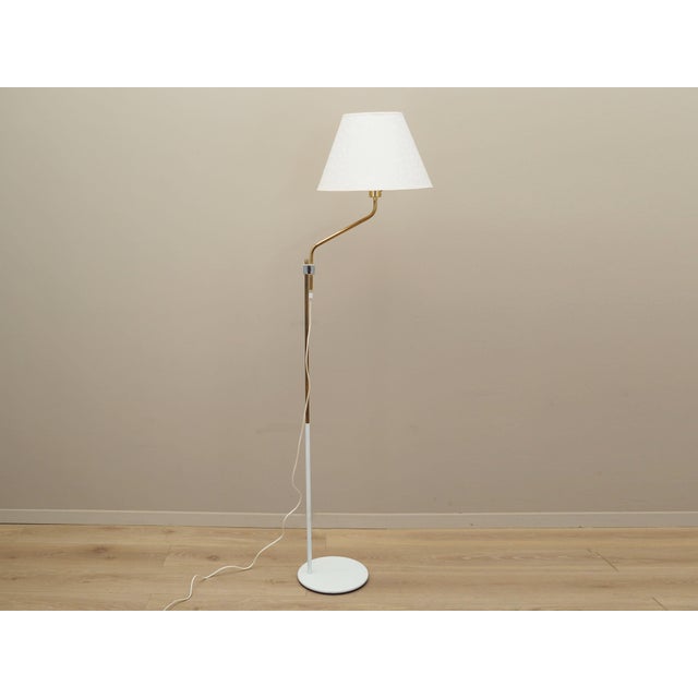 The lamp was made in the 1970s, Danish production. Made of metal. The lampshade is covered with fabric in white....