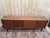 Scandinavian-style sideboard, circa 1960, crafted from solid teak and teak veneer on a plywood frame. The low, horizontal...