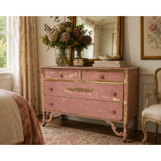 A wonderfully timeworn French Provincial-style chest of drawers distinguished by its authentic layered painted finish and...