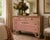 A wonderfully timeworn French Provincial-style chest of drawers distinguished by its authentic layered painted finish and...