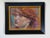 This artwork showcases a luminous portrait of a figure with striking red curls, capturing a moment of introspection. The...