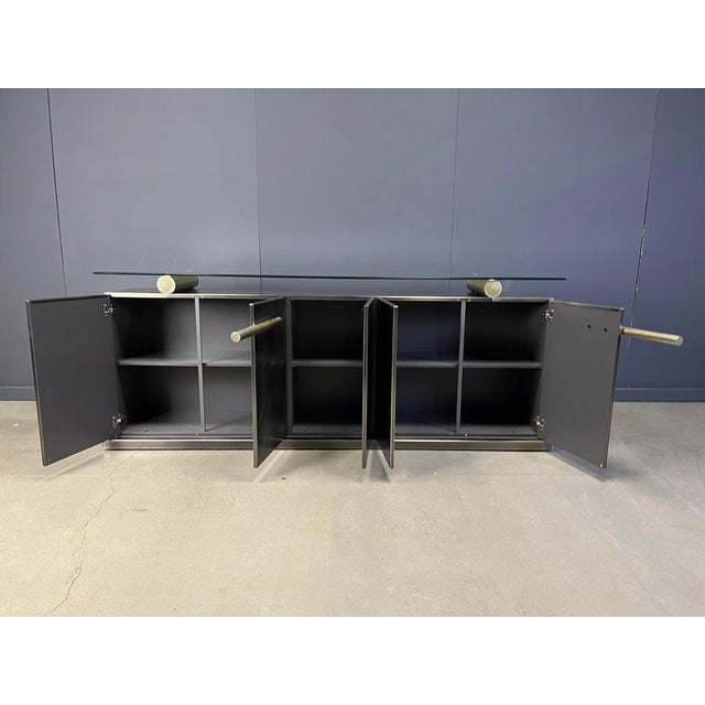 Luxurious heavy brass credenza with 5 doors and a glass top. Belgochrom made quality furniture with fine materials. This...