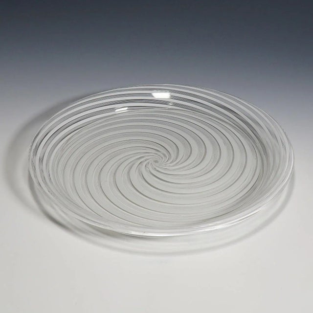 A large art glass plate made of clear glass with white filigrana bands. Most probably manufactured in Murano in the 19th...