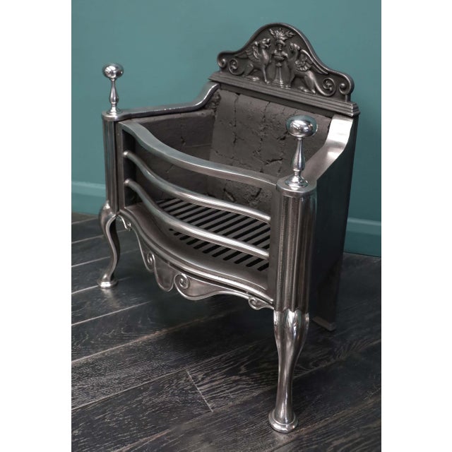A fine English 19th century polished steel fire basket by Thomas Elsley of London, with scrolled fret set between shaped...