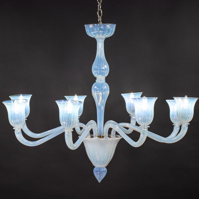 This spectacularly large vintage eight-arm Murano chandelier is a defining statement piece of lighting art, crafted in the...