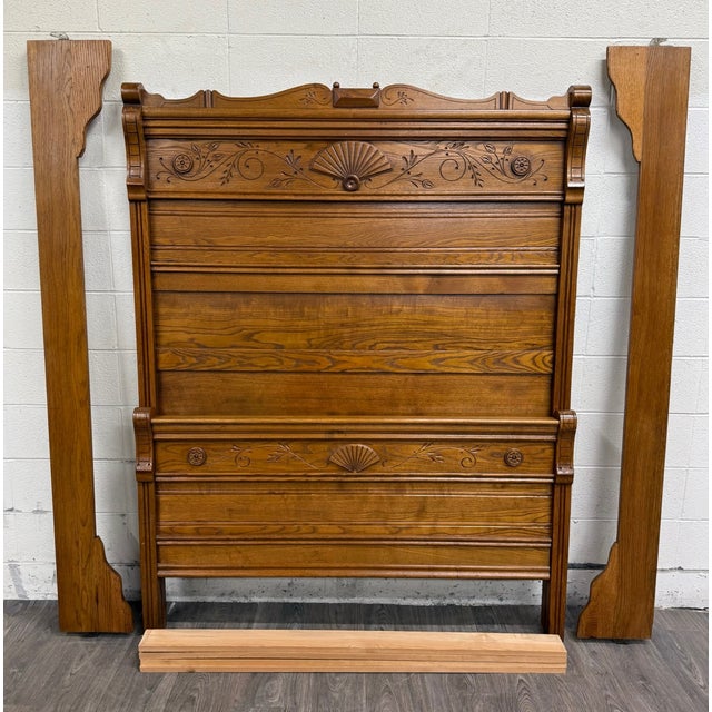 This is a gorgeous antique Victorian Eastlake full-size carved oak high-back bed. Features ornate fan, floral, and...