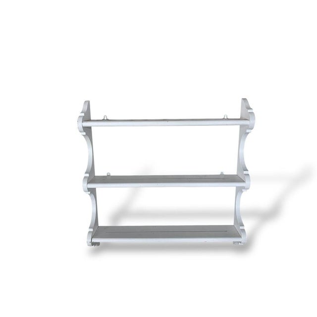 A charming vintage oak wall-mounted display rack, later painted in a soft shabby chic white finish. Featuring three narrow...
