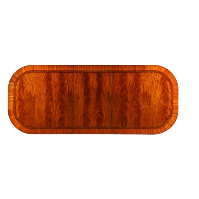 Top: Swirl mahogany veneer with ebony and boxwood banding Base: Rubbed black finish with antique gold accents on double...