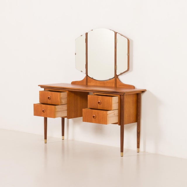 This elegant Scandinavian teak mid-century dressing table comes from the 1960s. It's a fine example of mid-century...