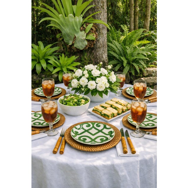 A vibrant set of possibly Artisan de Luxe Home 9-inch melamine plates featuring the brand’s signature Green Scroll lattice...