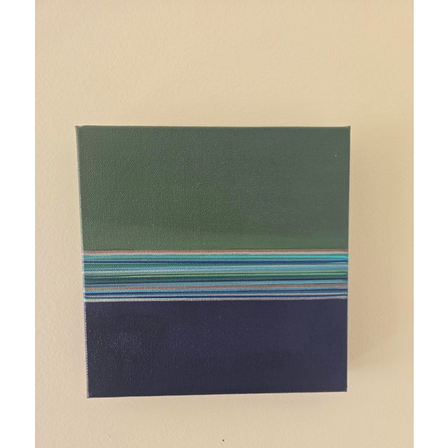 Greens and blues move across the canvas in a quiet rhythm, layered like notes in a melody. Cadence explores the harmony...