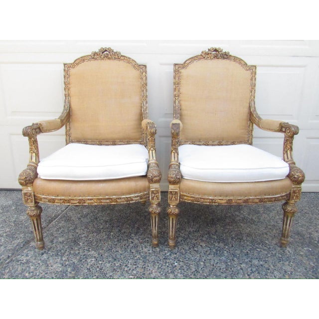 A pair of antique French Louis XVI style armchairs or fauteuils, c.1900 A good looking pair of chairs in distressed...