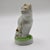A charming, authentic 19th-century antique English Staffordshire pottery miniature cabinet figurine depicting an alert,...
