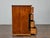 This French Empire walnut commode presents the clean architectural lines and restrained ornamentation associated with the...