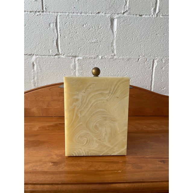 A sophisticated and substantial ice bucket crafted from faux onyx stone. Dating to the late 20th century, this piece...