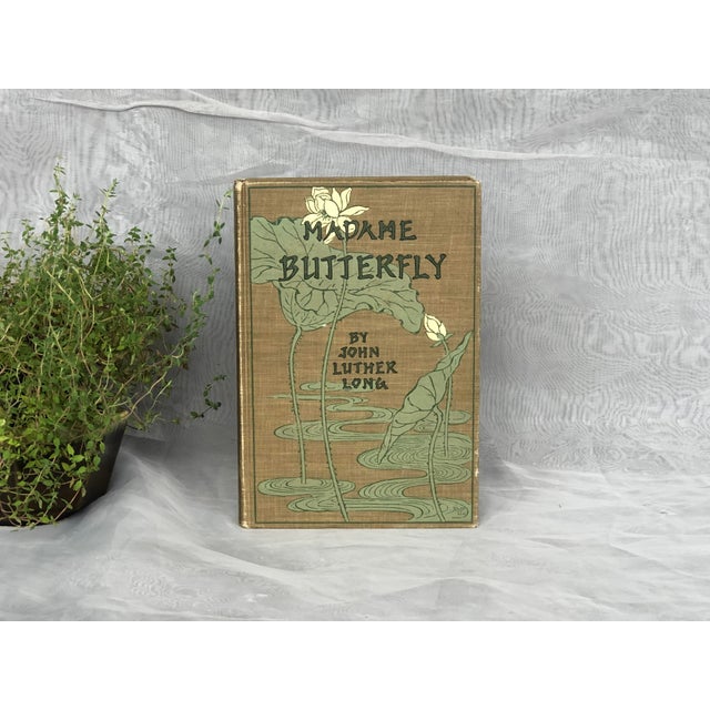 This antique edition of Madame Butterfly by John Luther Long has a beautiful decorative cover with water lily flowers....